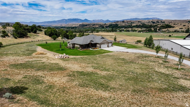 3123 East Riverdale Road Preston, ID 83263 - Photo 42 of 52 Ranch-style residence featuring a dark gray roof, a three-car garage, and a concrete driveway