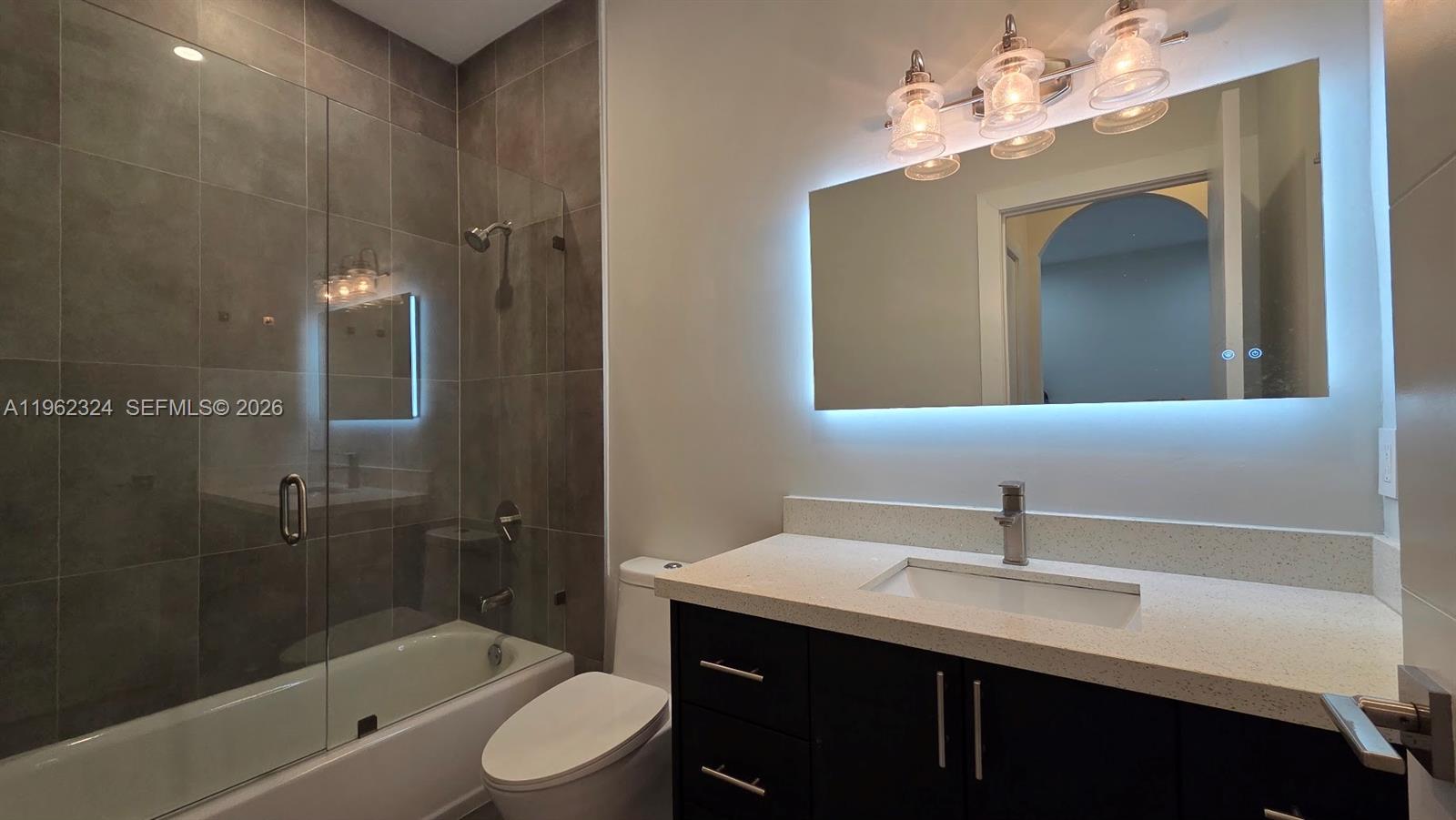 17820 Northwest 73rd Avenue, Unit 2031 Hialeah, FL 33015 - Photo 8 of 11 a bathroom with a sink a toilet and shower