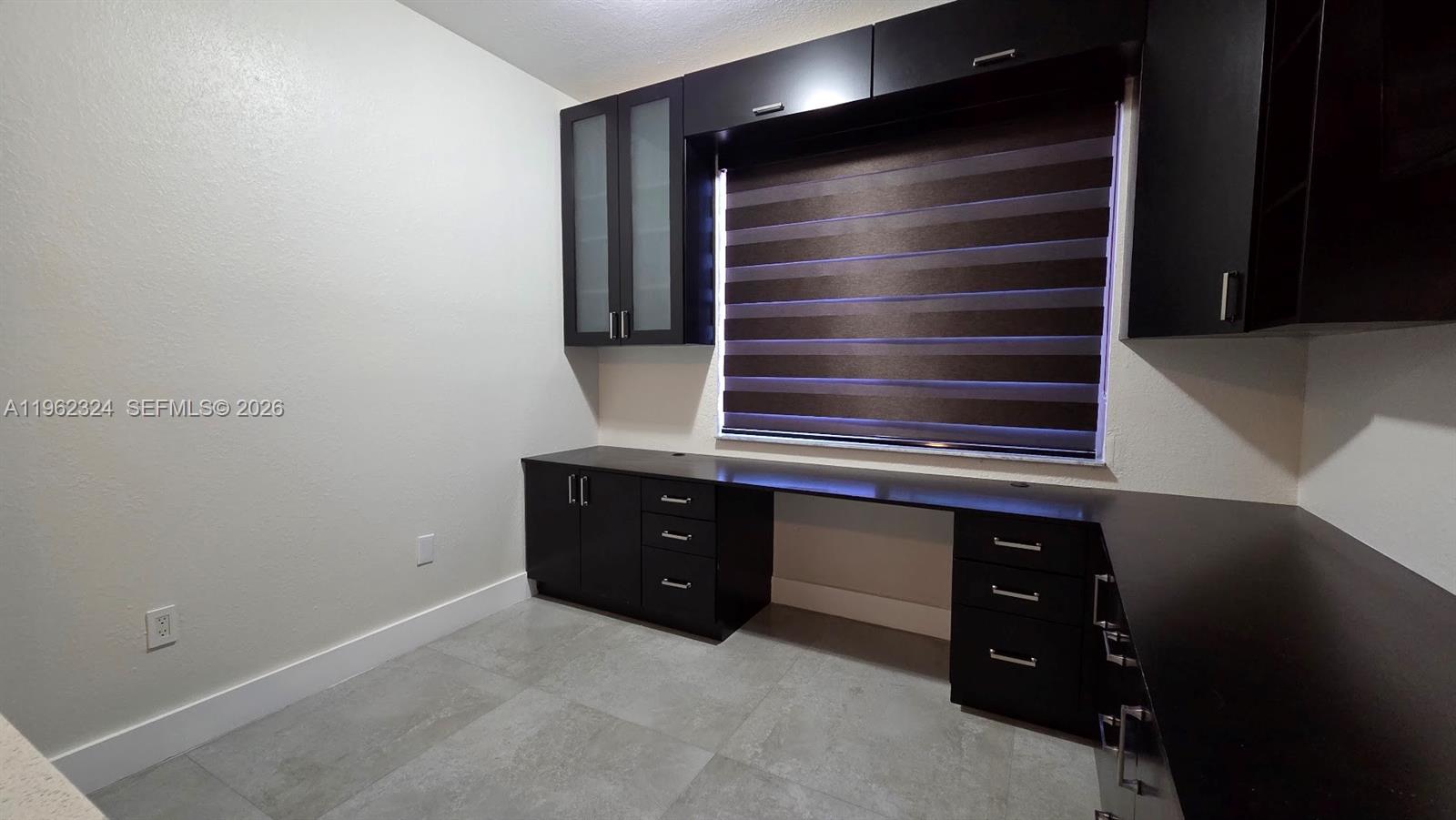 17820 Northwest 73rd Avenue, Unit 2031 Hialeah, FL 33015 - Photo 10 of 11 a kitchen with wooden cabinets and a sink