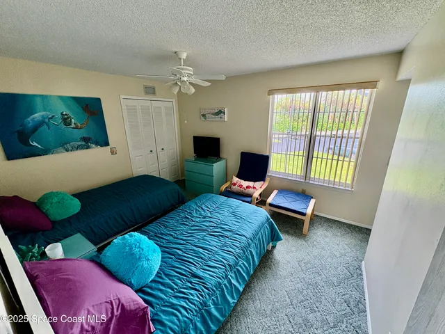 a bedroom with furniture and a window