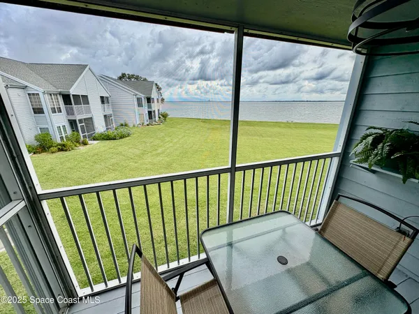 an aerial view of a house with a lake view
