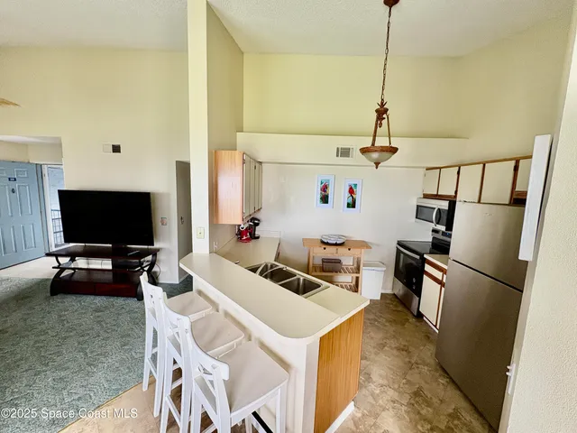 a view of a livingroom with furniture and a flat screen tv