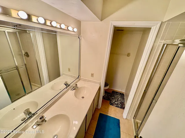 a bathroom with a sink a tub and a mirror
