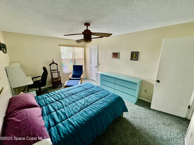 a bedroom with a bed a window and furniture