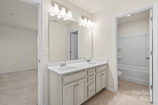a spacious bathroom with a double vanity sink mirror and a