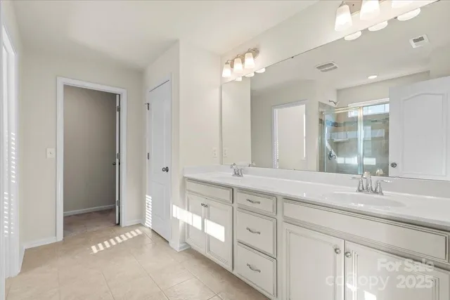 a spacious bathroom with a double vanity sink mirror and double