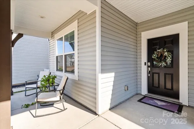 a view of a chairs and table in a back yard