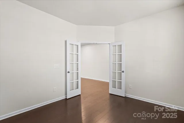 an empty room with wooden floor