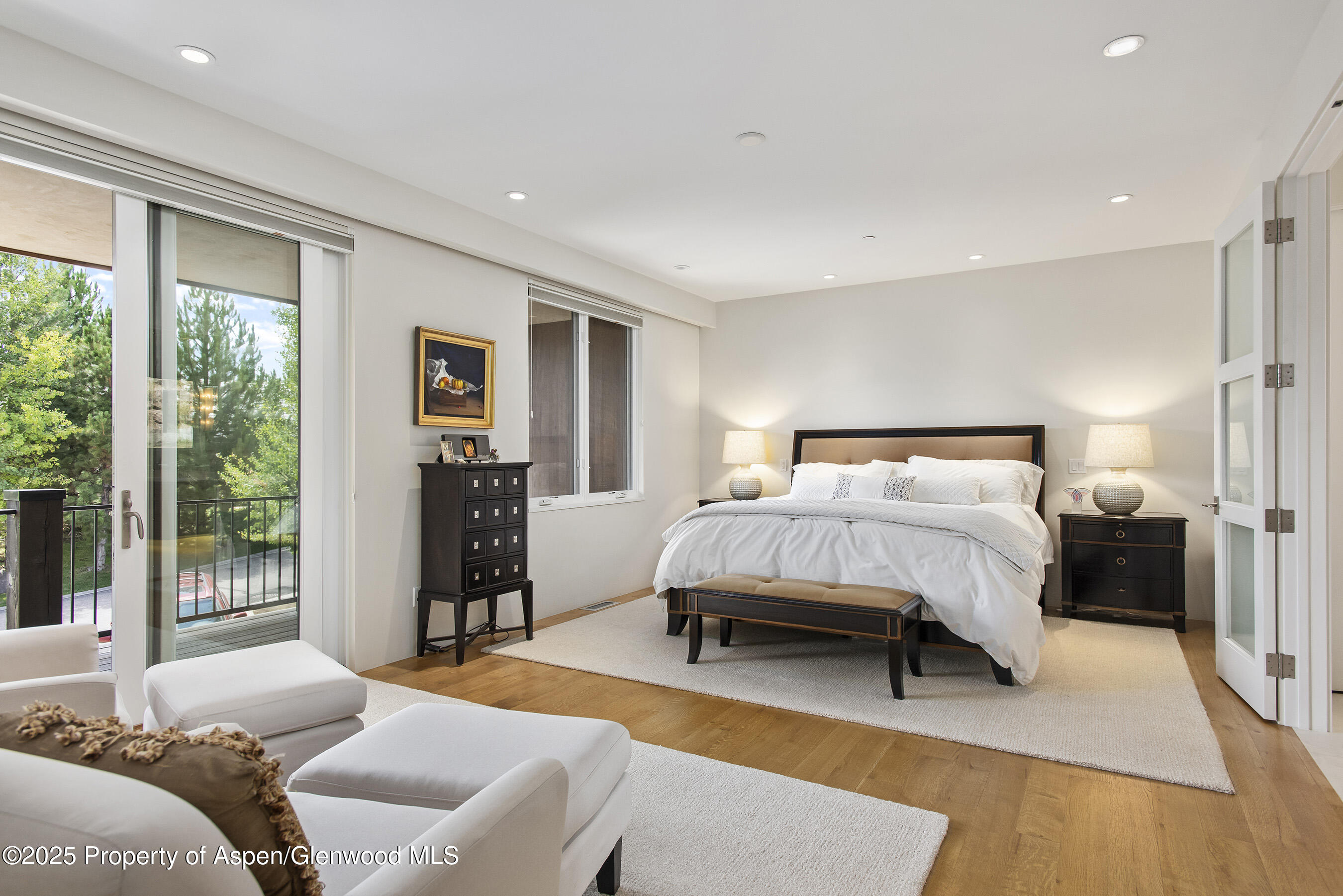 751 Promontory Lane Basalt, CO 81621 - Photo 13 of 41 a bedroom with a bed and a dresser with wooden floor