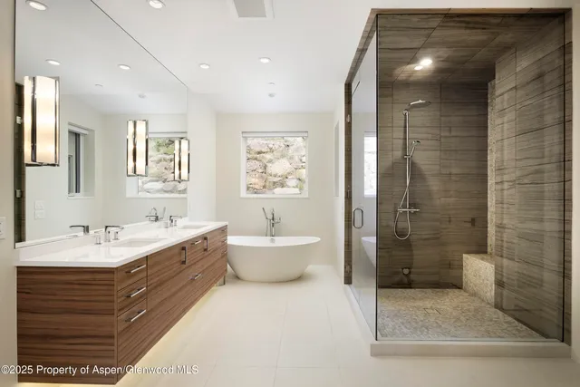a bathroom with a double vanity sink toilet and shower