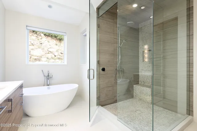 a bathroom with a bathtub and shower