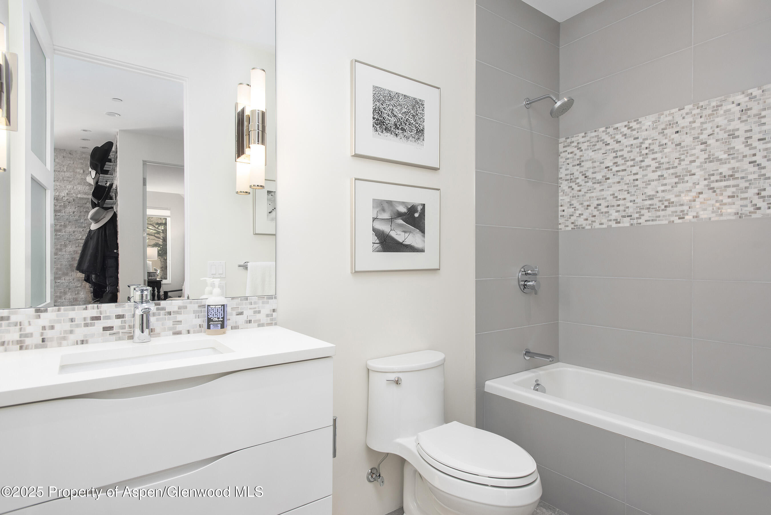 751 Promontory Lane Basalt, CO 81621 - Photo 20 of 41 a bathroom with a toilet a sink a mirror a lamp a bathtub and vanity