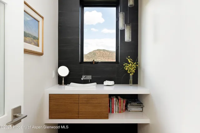 a view of bathroom with a sink and a window