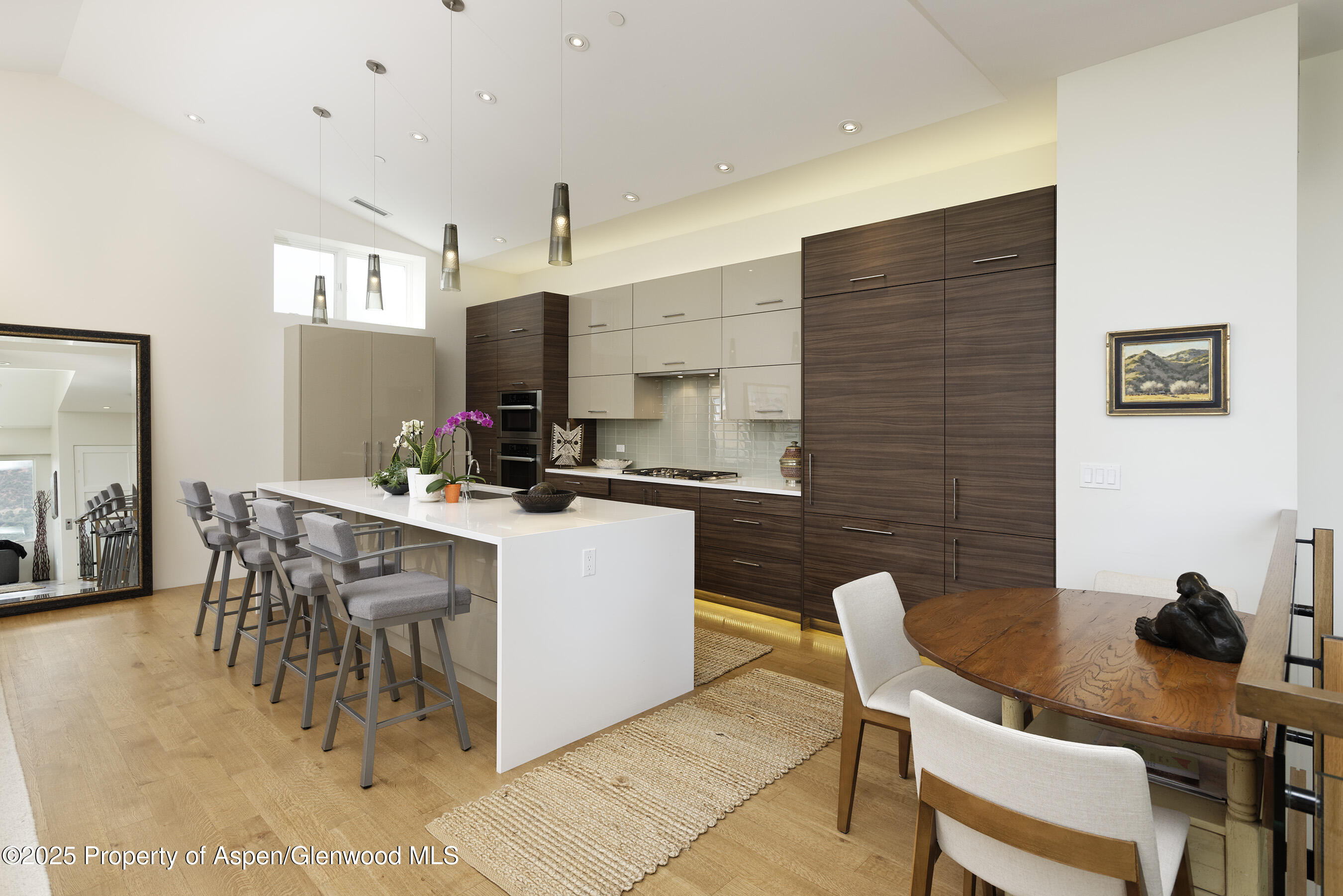 751 Promontory Lane Basalt, CO 81621 - Photo 3 of 41 a kitchen with a dining table chairs and a refrigerator