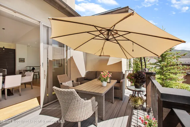a front view of a house with a yard and mountain view in back