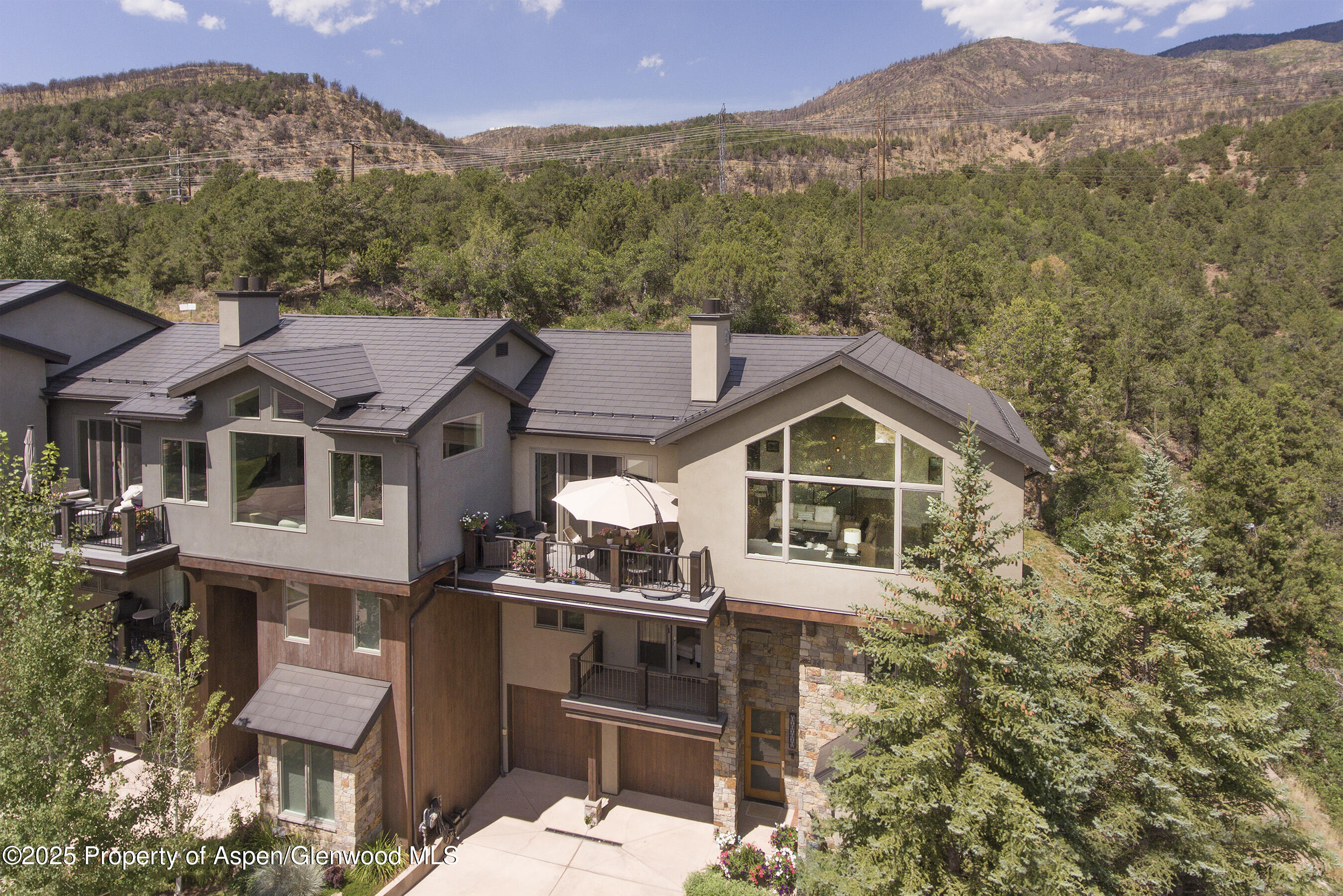 751 Promontory Lane Basalt, CO 81621 - Photo 35 of 41 a front view of a house with a yard and mountain view in back