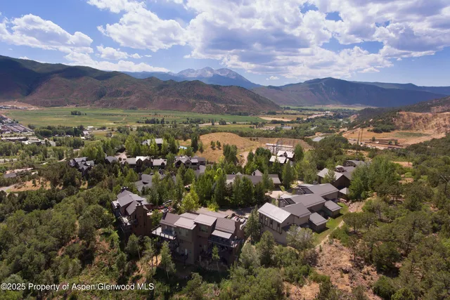 a view of a dry yard with wooden fence
