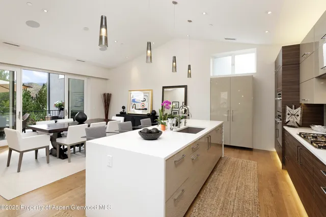 a view of living room kitchen with stainless steel appliances granite countertop furniture and a large window