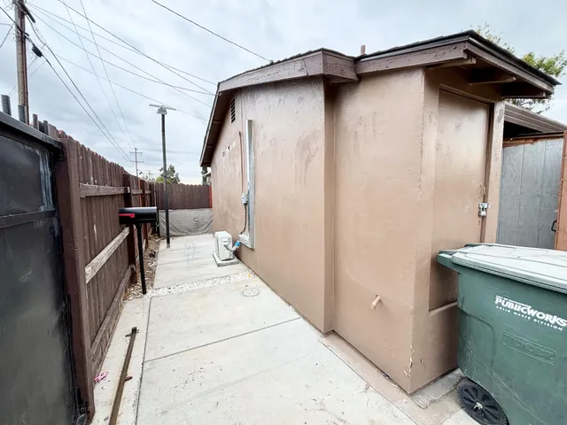 a view of a backyard with a small cabin and a chair
