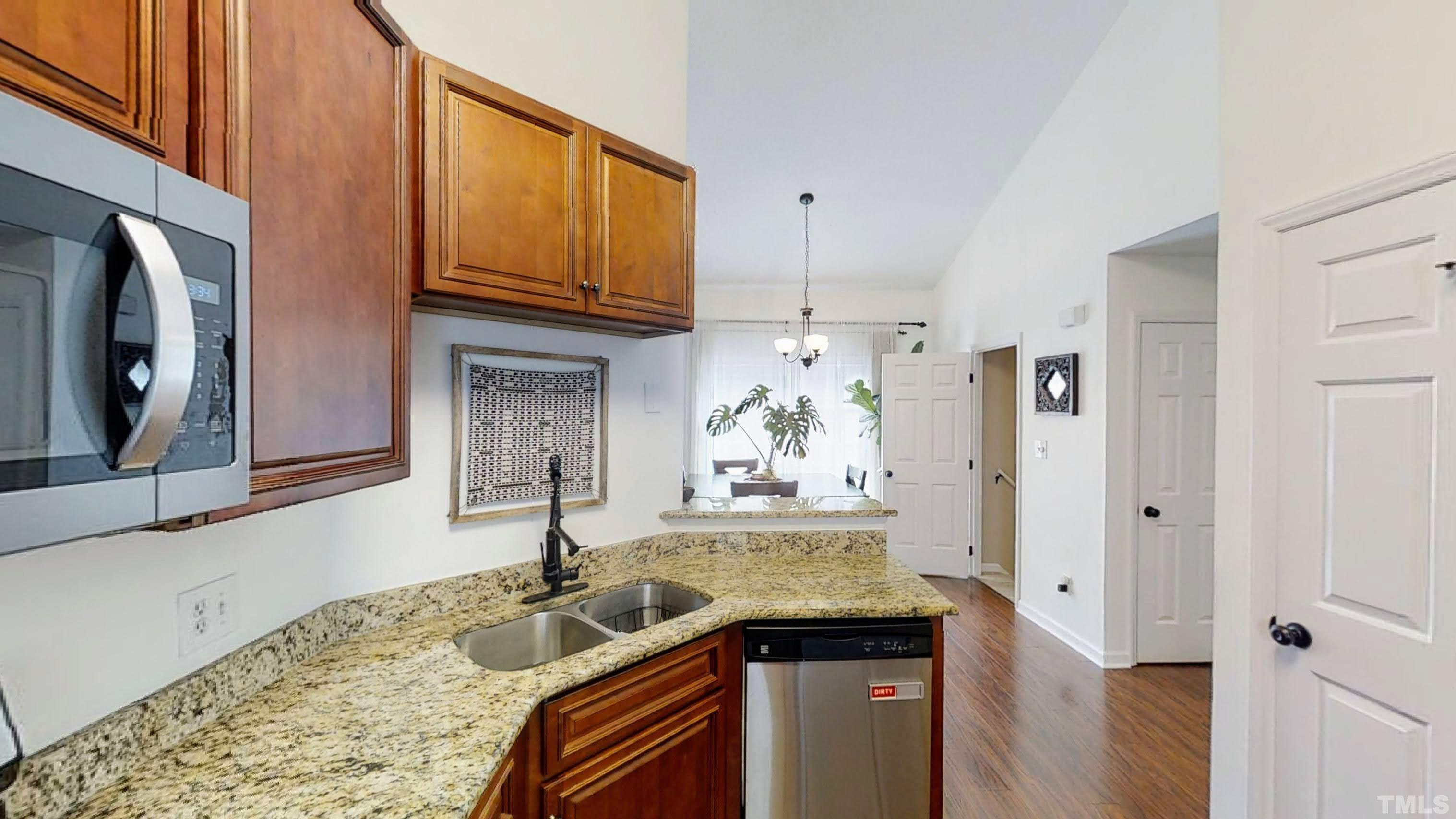 424 Dickens Drive Raleigh, NC 27610 - Photo 13 of 33 a kitchen with stainless steel appliances granite countertop a sink and cabinets
