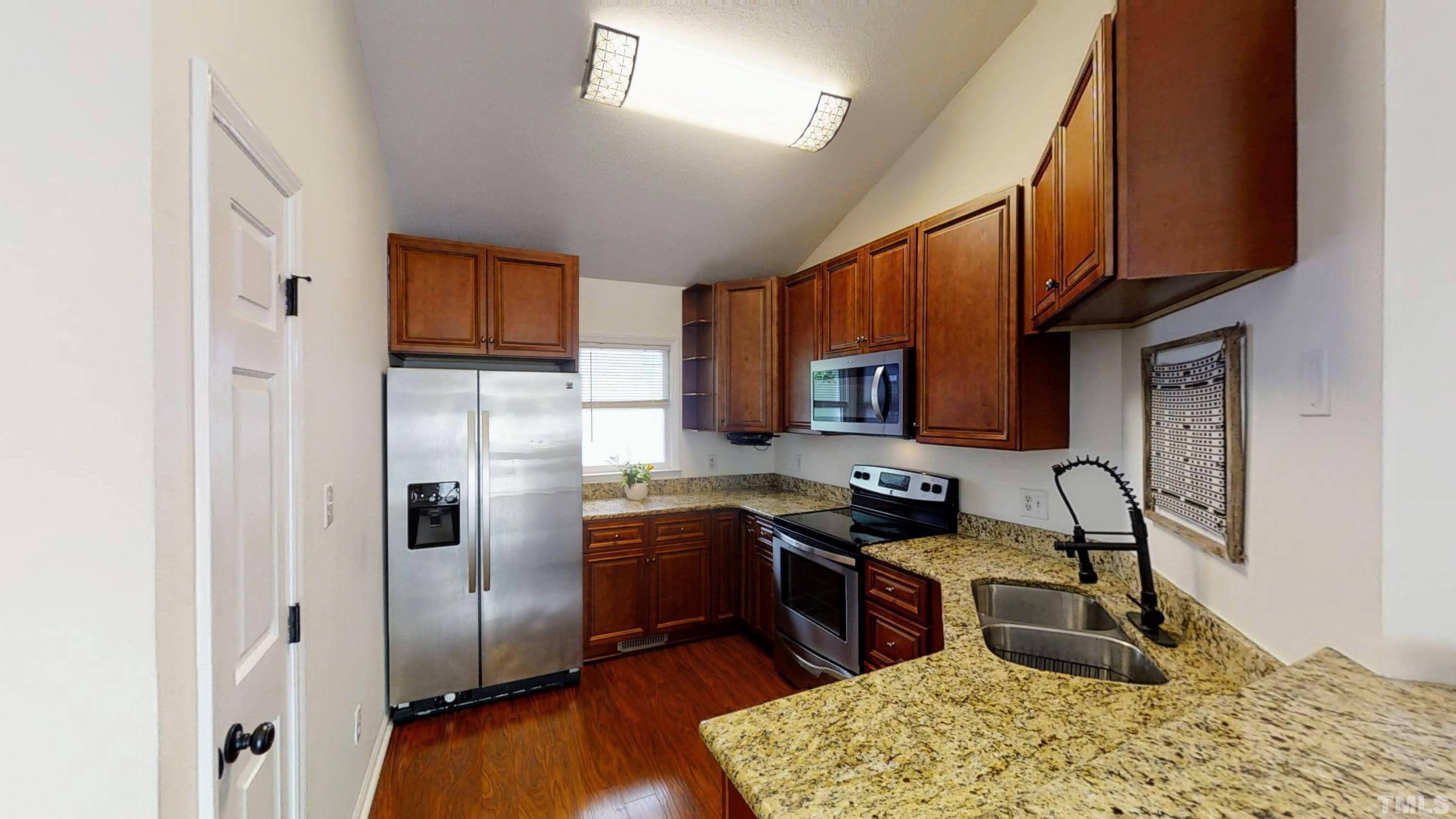 424 Dickens Drive Raleigh, NC 27610 - Photo 14 of 33 a kitchen with stainless steel appliances granite countertop a refrigerator stove top oven and sink