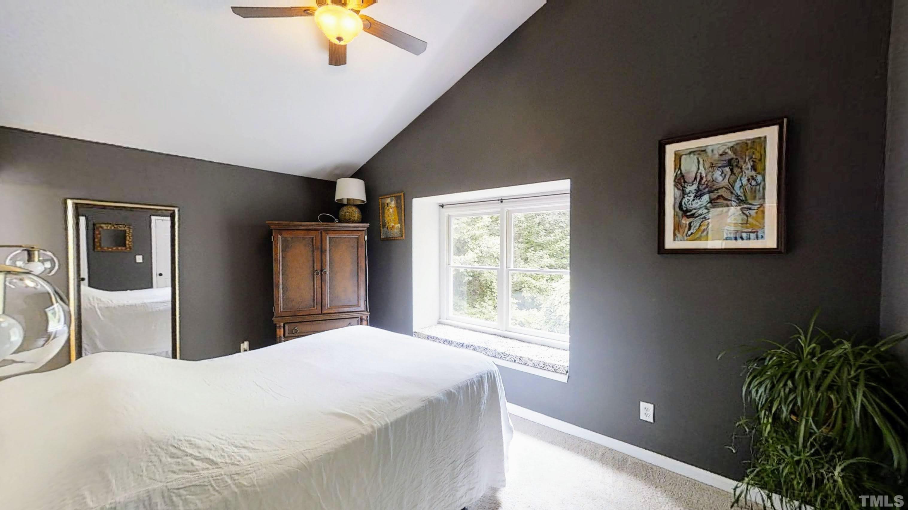 424 Dickens Drive Raleigh, NC 27610 - Photo 15 of 33 a bedroom with a large bed and a chandelier