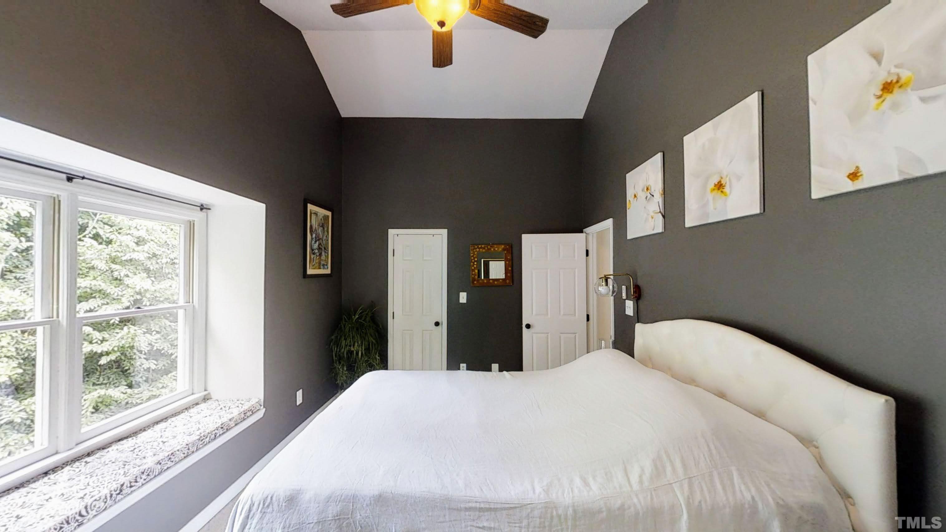 424 Dickens Drive Raleigh, NC 27610 - Photo 17 of 33 a bedroom with a bed and a large window