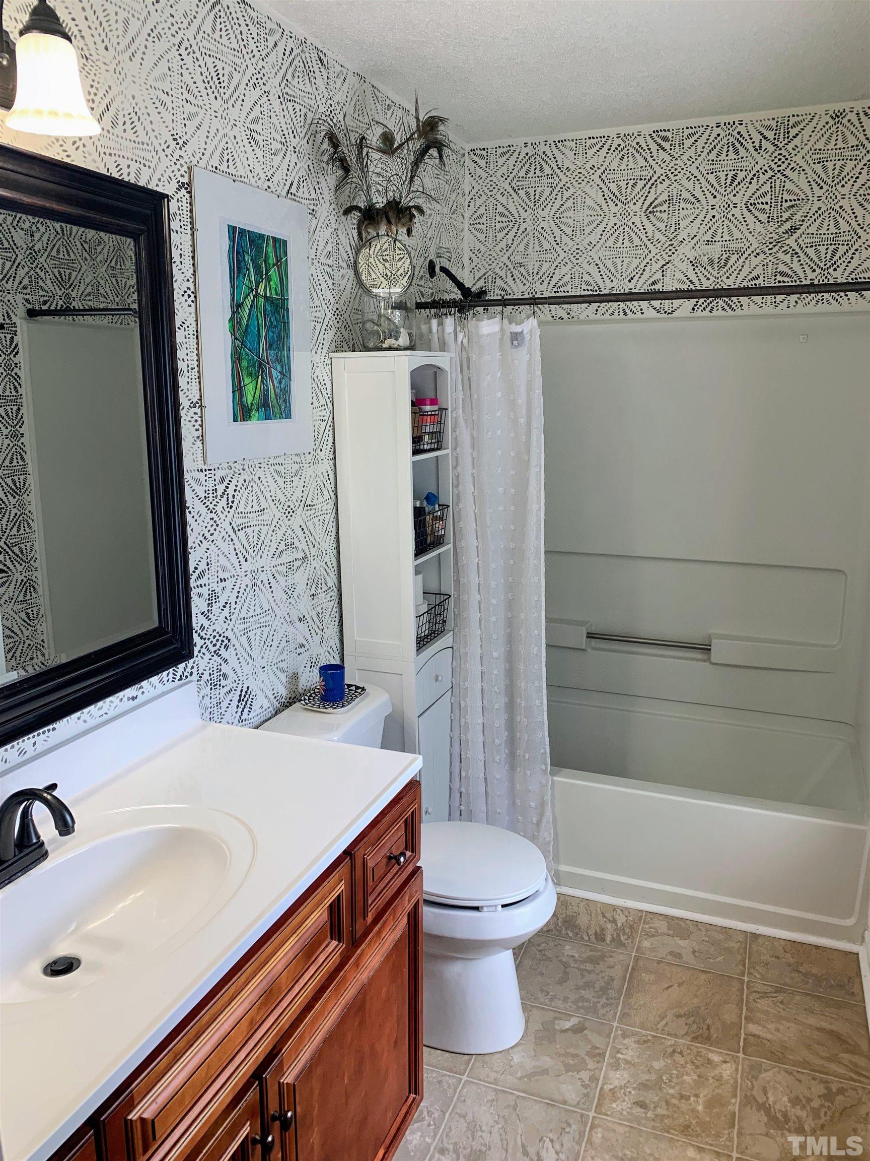 424 Dickens Drive Raleigh, NC 27610 - Photo 18 of 33 a bathroom with a sink toilet and shower