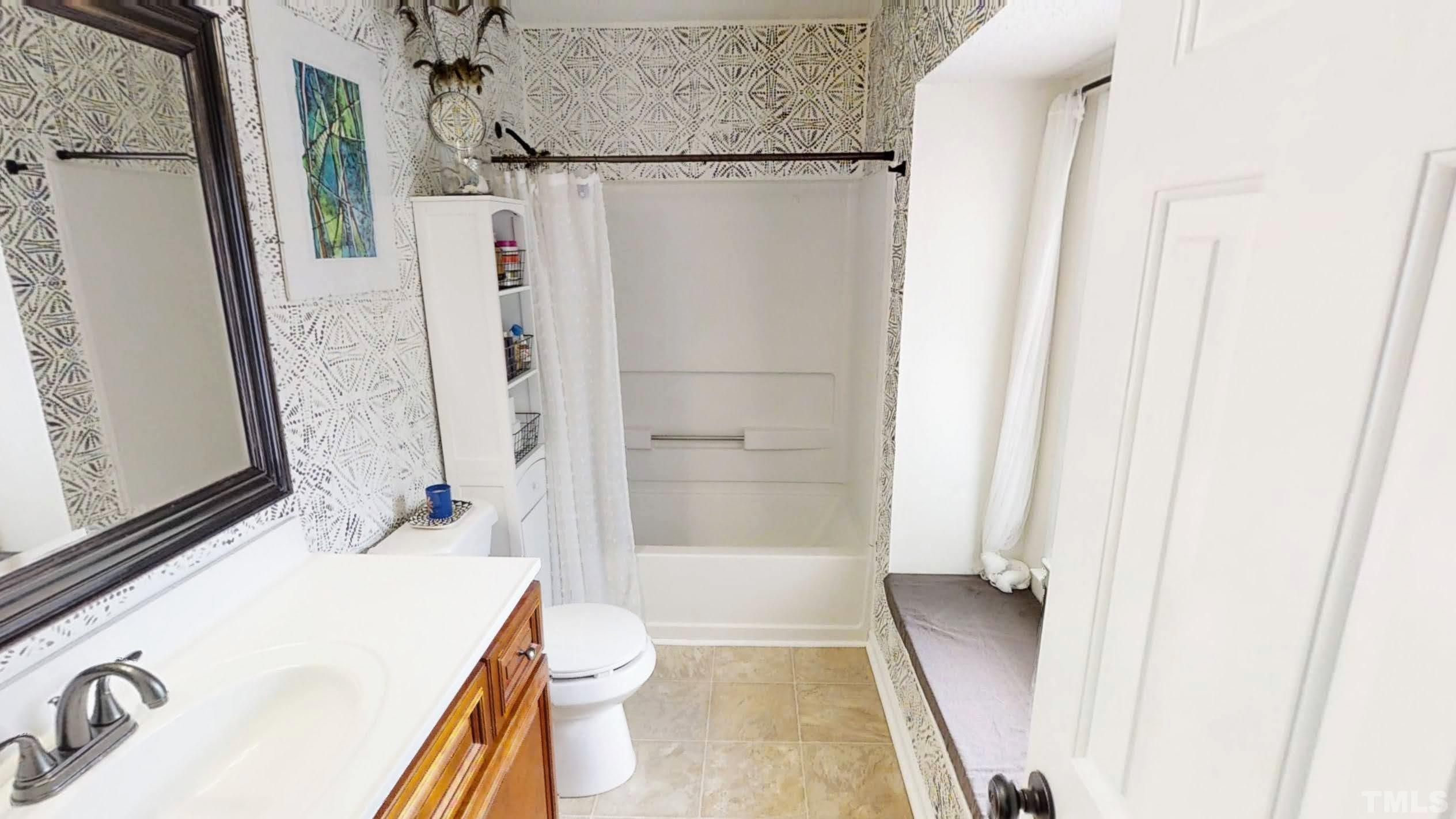 424 Dickens Drive Raleigh, NC 27610 - Photo 19 of 33 a bathroom with a sink a toilet a tub and shower