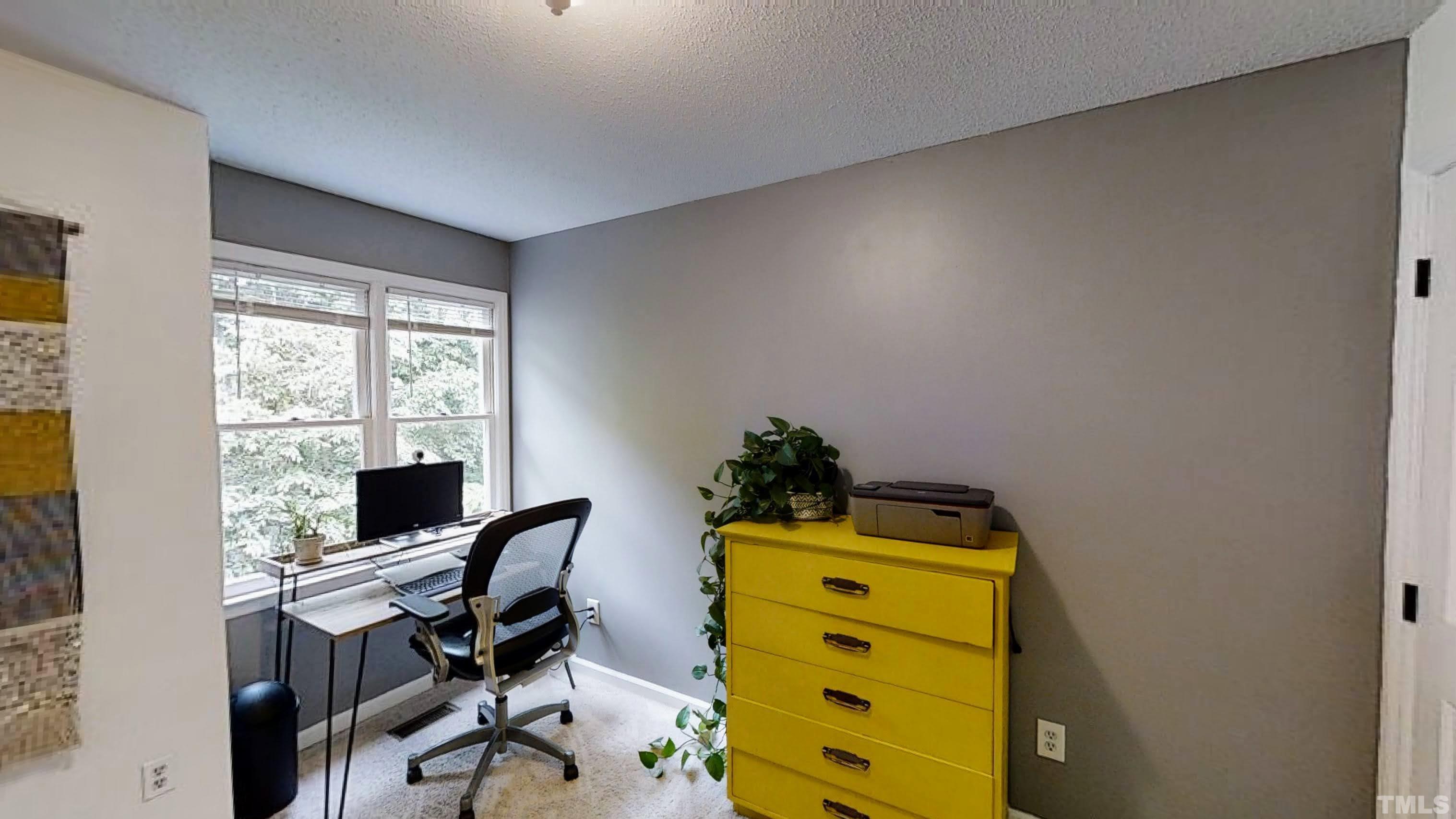 424 Dickens Drive Raleigh, NC 27610 - Photo 20 of 33 a room with a desk and chair with chandelier