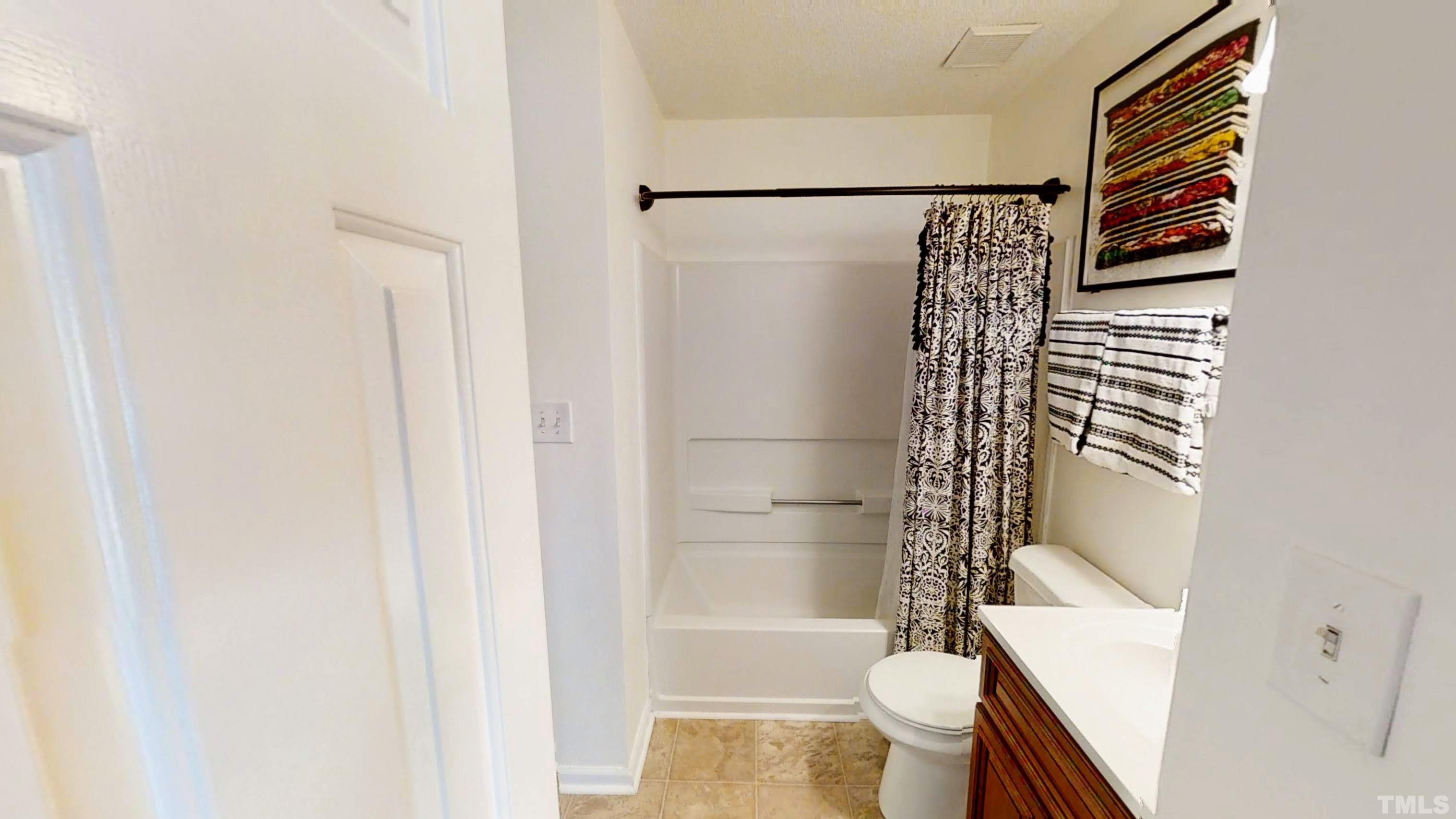 424 Dickens Drive Raleigh, NC 27610 - Photo 22 of 33 a bathroom with a shower and a toilet