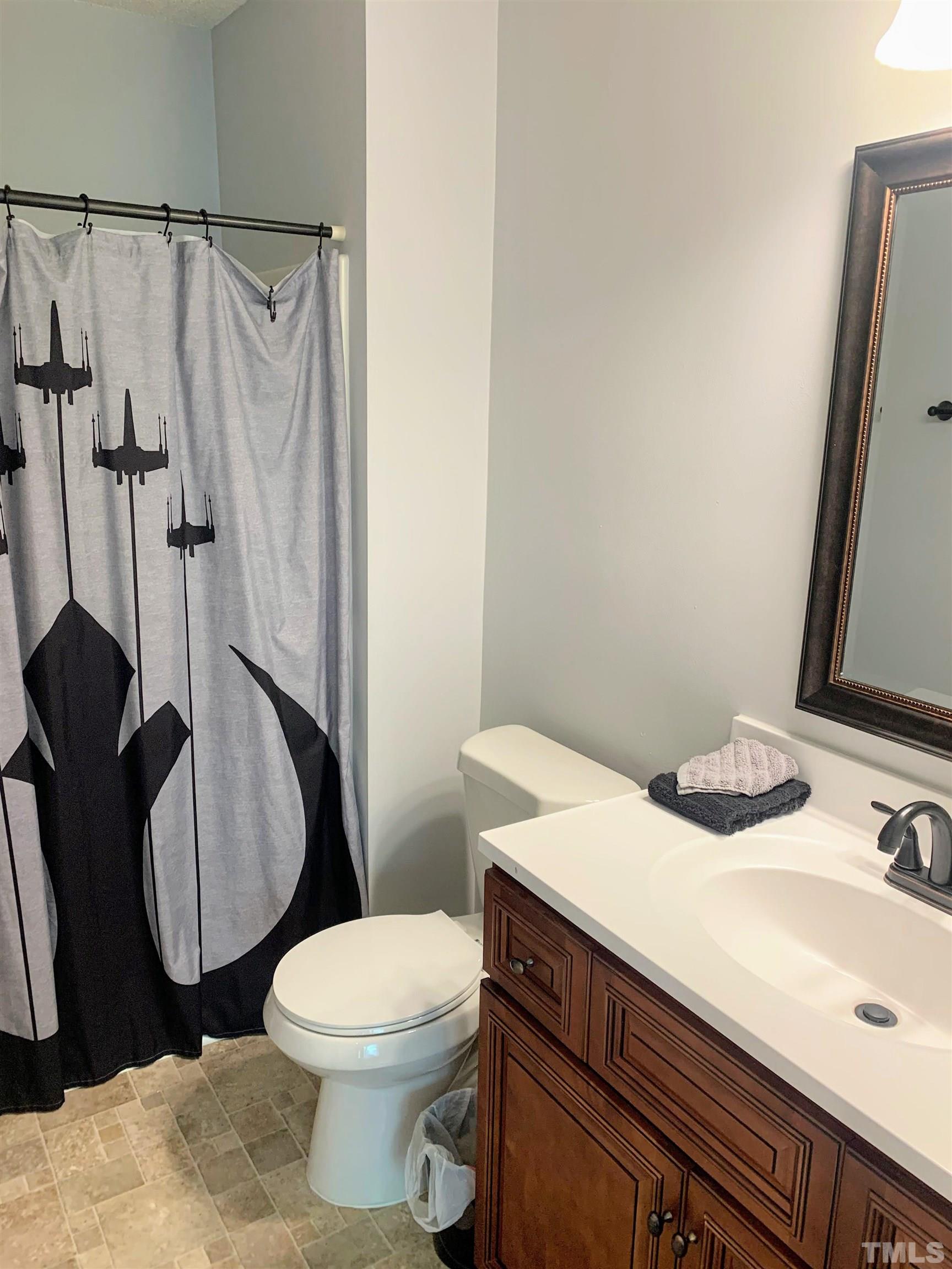 424 Dickens Drive Raleigh, NC 27610 - Photo 29 of 33 a bathroom with a sink a toilet and shower