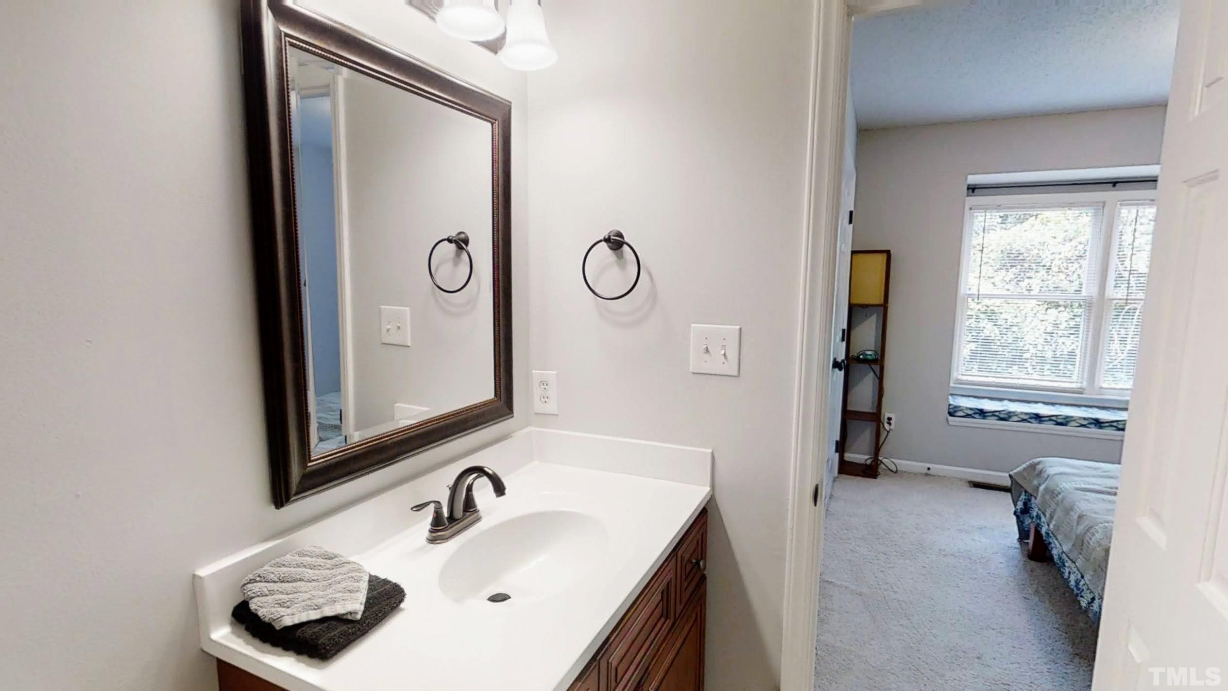 424 Dickens Drive Raleigh, NC 27610 - Photo 30 of 33 a bathroom with a sink and a mirror