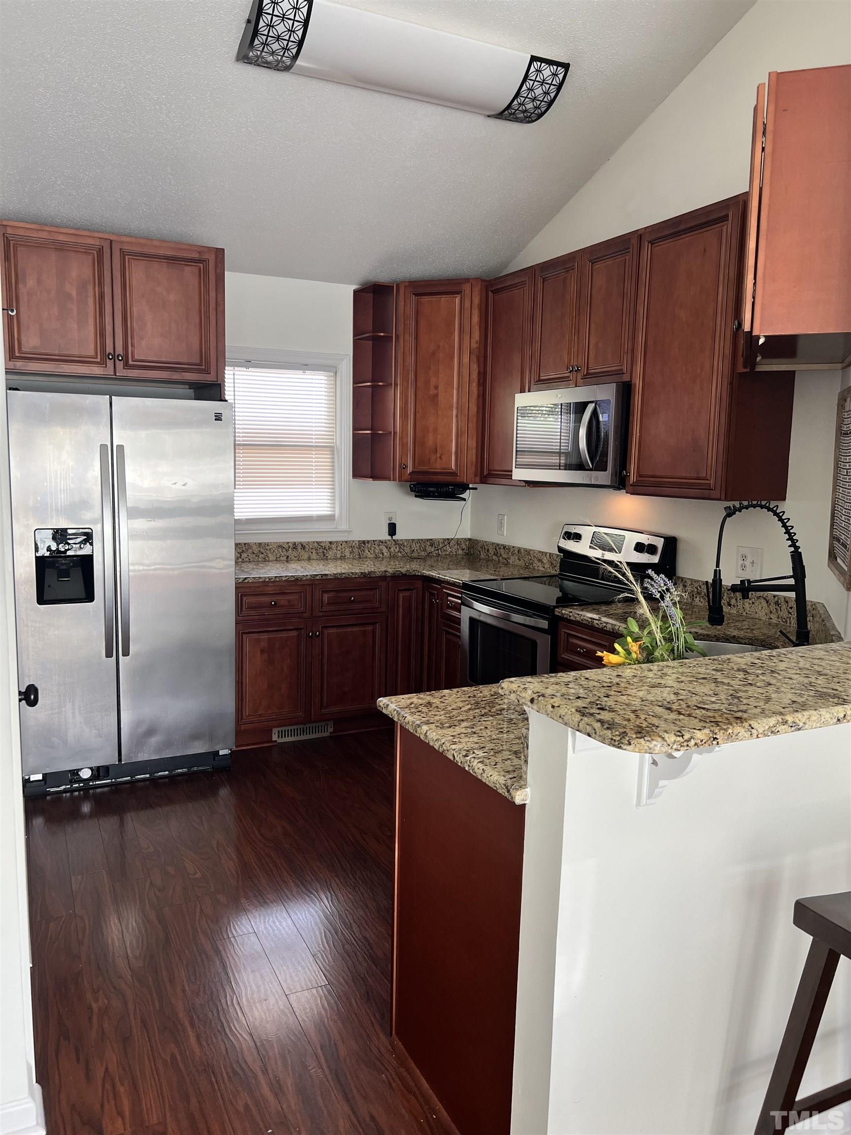424 Dickens Drive Raleigh, NC 27610 - Photo 4 of 33 a kitchen with stainless steel appliances granite countertop a sink stove and refrigerator