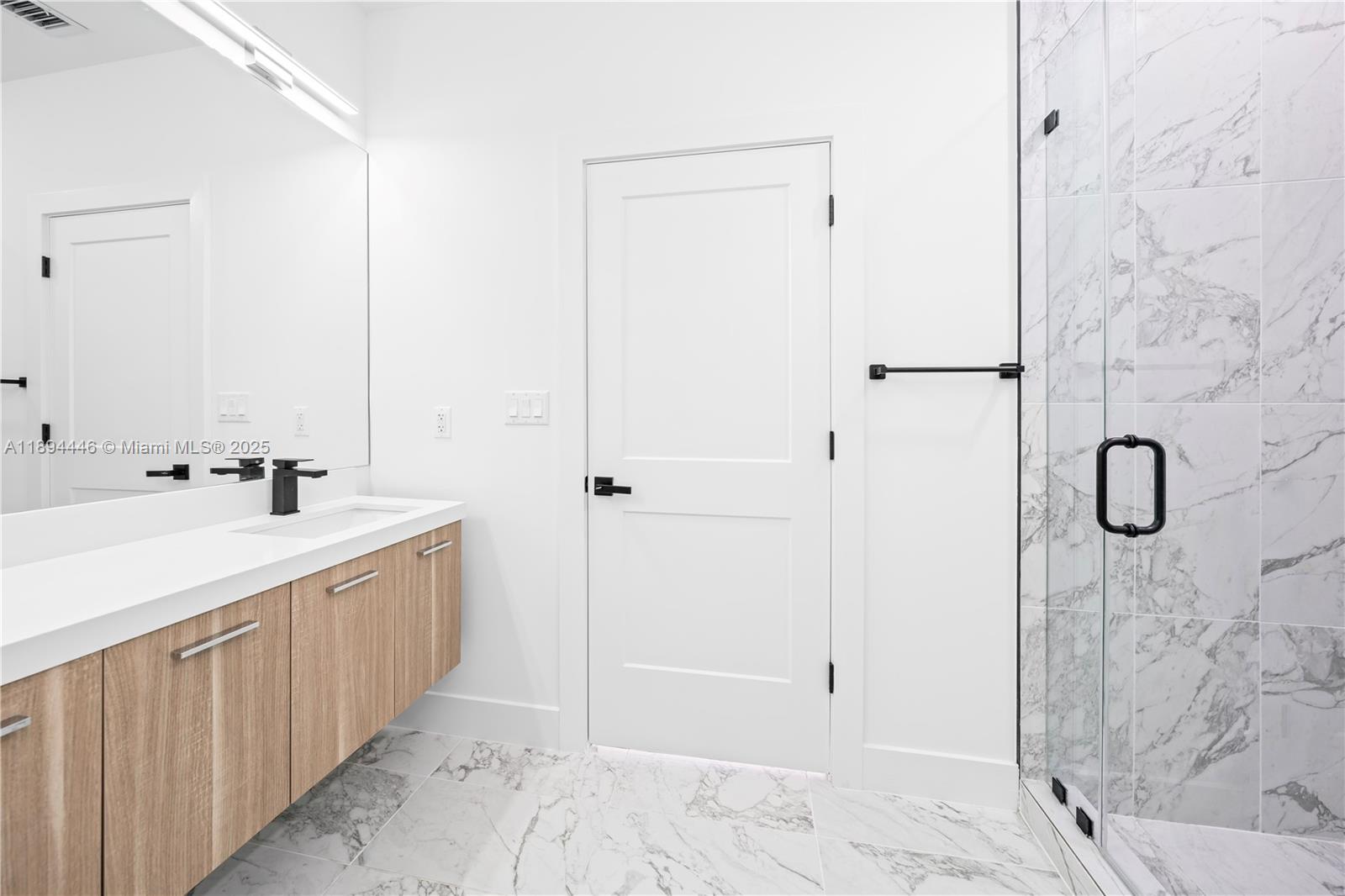 526 Southwest 2nd Street, Unit 1 Miami, FL 33130 - Photo 20 of 36 a bathroom with a double vanity sink and shower