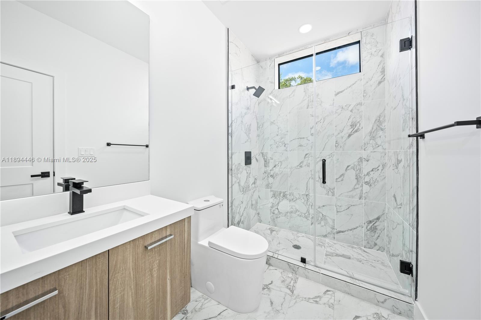 526 Southwest 2nd Street, Unit 1 Miami, FL 33130 - Photo 23 of 36 a bathroom with a sink a toilet and shower