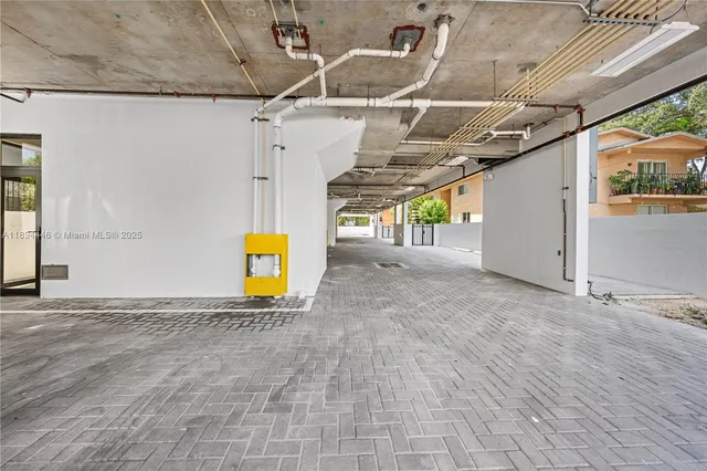 an aerial view of residential houses with outdoor space and trees all around