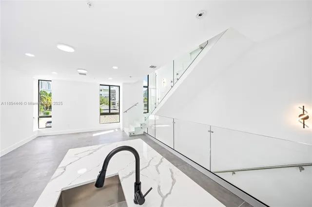 a view of an entryway with wooden floor