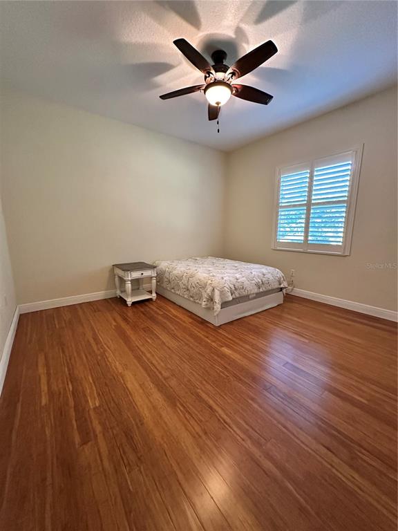 8209 Southwest 196th Ct Road Dunnellon, FL 34432 - Photo 18 of 29 a bedroom with a bed and wooden floor
