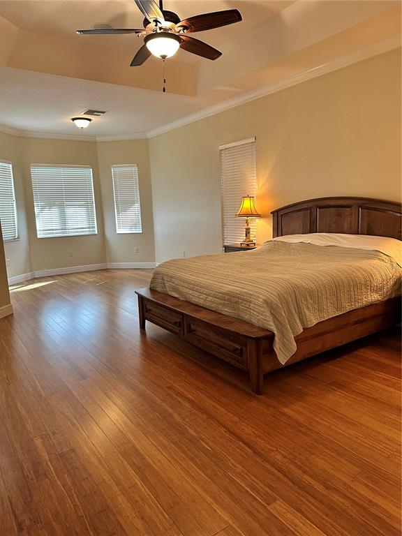 8209 Southwest 196th Ct Road Dunnellon, FL 34432 - Photo 19 of 29 a spacious bedroom with a bed and wooden floor