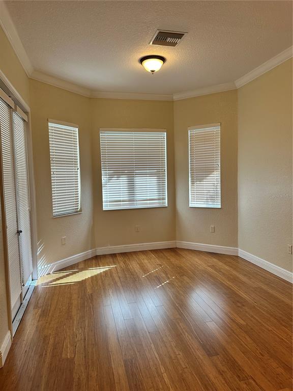 8209 Southwest 196th Ct Road Dunnellon, FL 34432 - Photo 20 of 29 a view of an empty room with wooden floor and a window