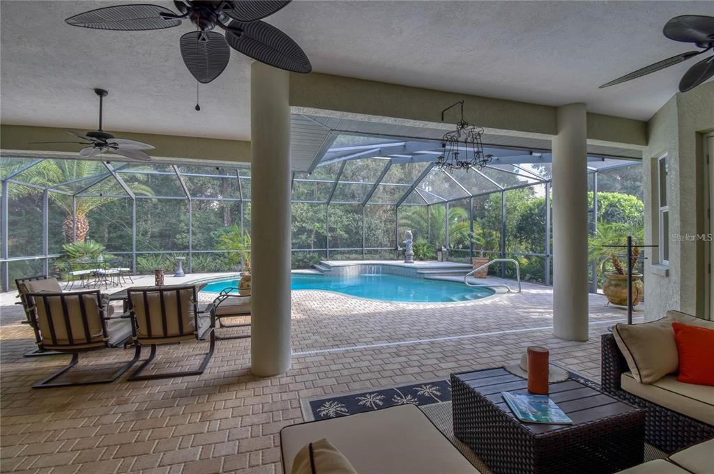 8209 Southwest 196th Ct Road Dunnellon, FL 34432 - Photo 22 of 29 a living room with patio furniture and a floor to ceiling window