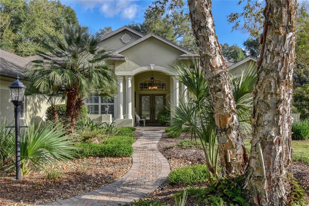 8209 Southwest 196th Ct Road Dunnellon, FL 34432 - Photo 3 of 29 a front view of a house with garden