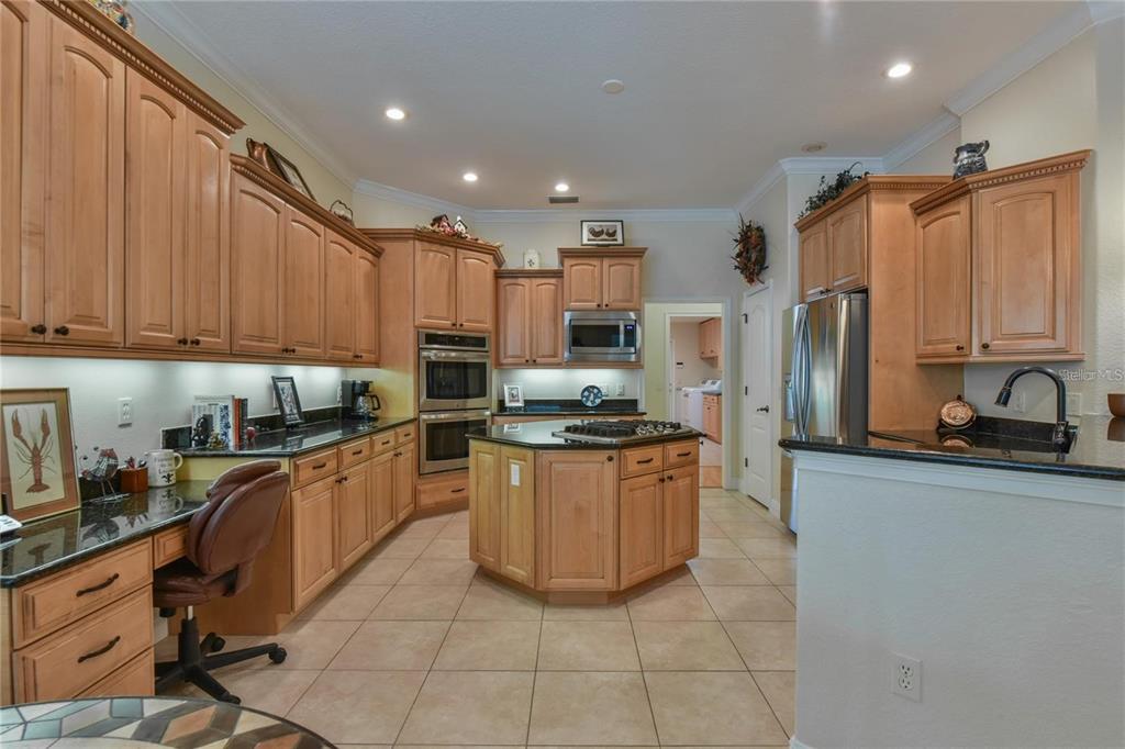 8209 Southwest 196th Ct Road Dunnellon, FL 34432 - Photo 8 of 29 a kitchen with stainless steel appliances granite countertop a refrigerator sink and cabinets