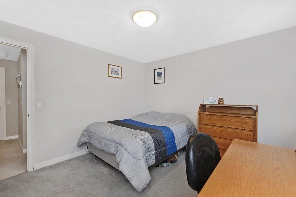 17 Nardone Road Needham, MA 02492 - Photo 13 of 22 a bedroom with a bed and a chair