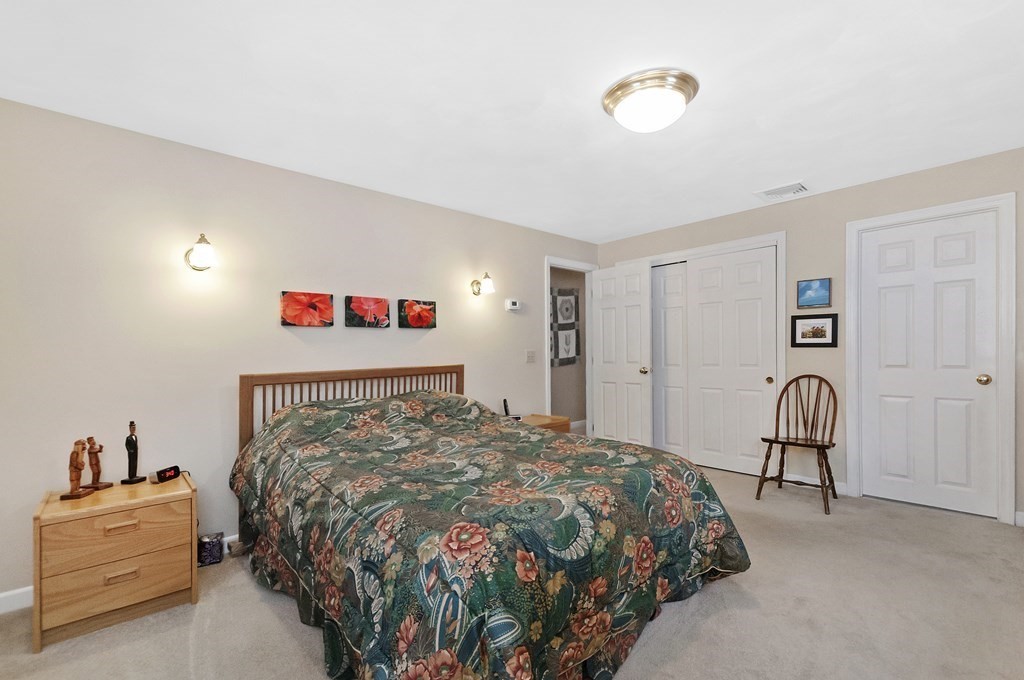 17 Nardone Road Needham, MA 02492 - Photo 16 of 22 a bedroom with a bed and a chandelier