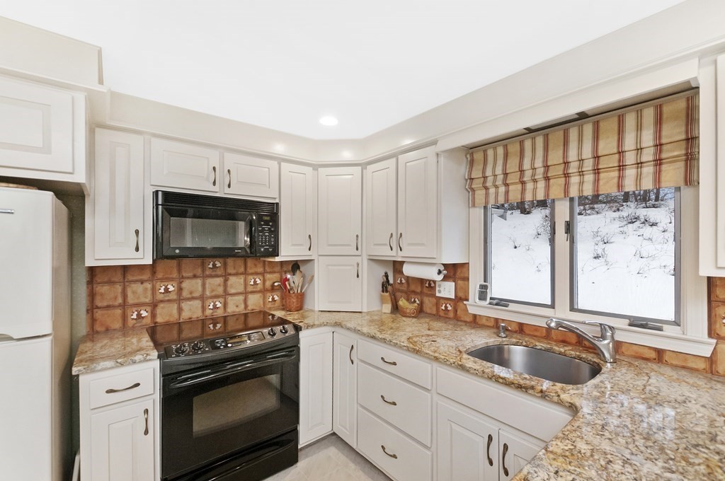 17 Nardone Road Needham, MA 02492 - Photo 3 of 22 a kitchen with stainless steel appliances granite countertop a sink stove and refrigerator