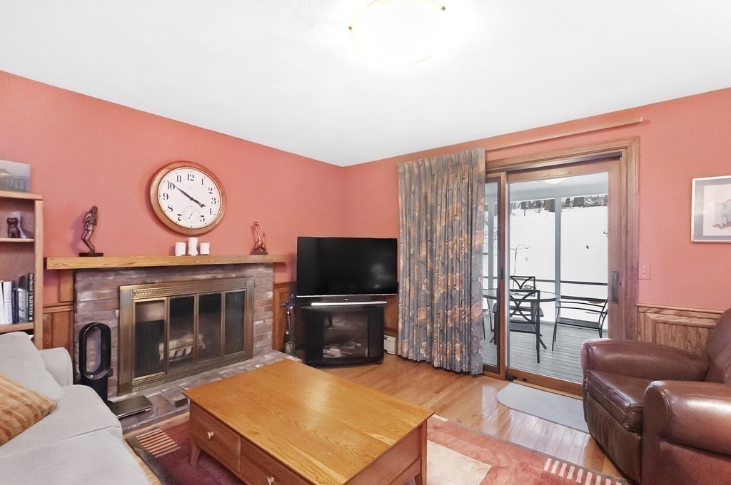 17 Nardone Road Needham, MA 02492 - Photo 10 of 22 a living room with furniture a fireplace and a flat screen tv