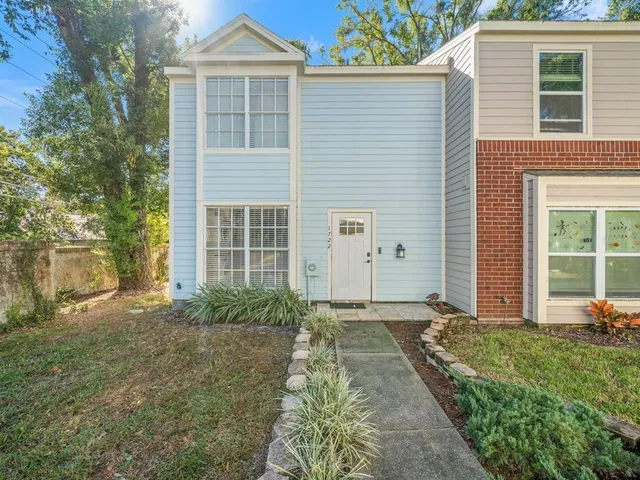 a front view of a house with garden