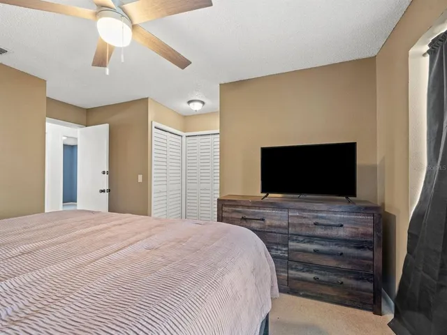 a bedroom with a bed and a flat screen tv